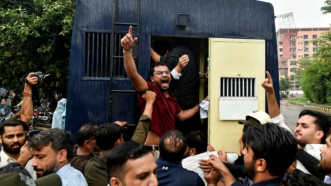 A protester is detained as he and others gather in support of the banned Joint Awami Action Committee (JAAC), an alliance of civil society groups in Pakistani Kashmir, during a demonstration in Lahore, Pakistan, July 31, 2026. REUTERS/Murtaza Ali