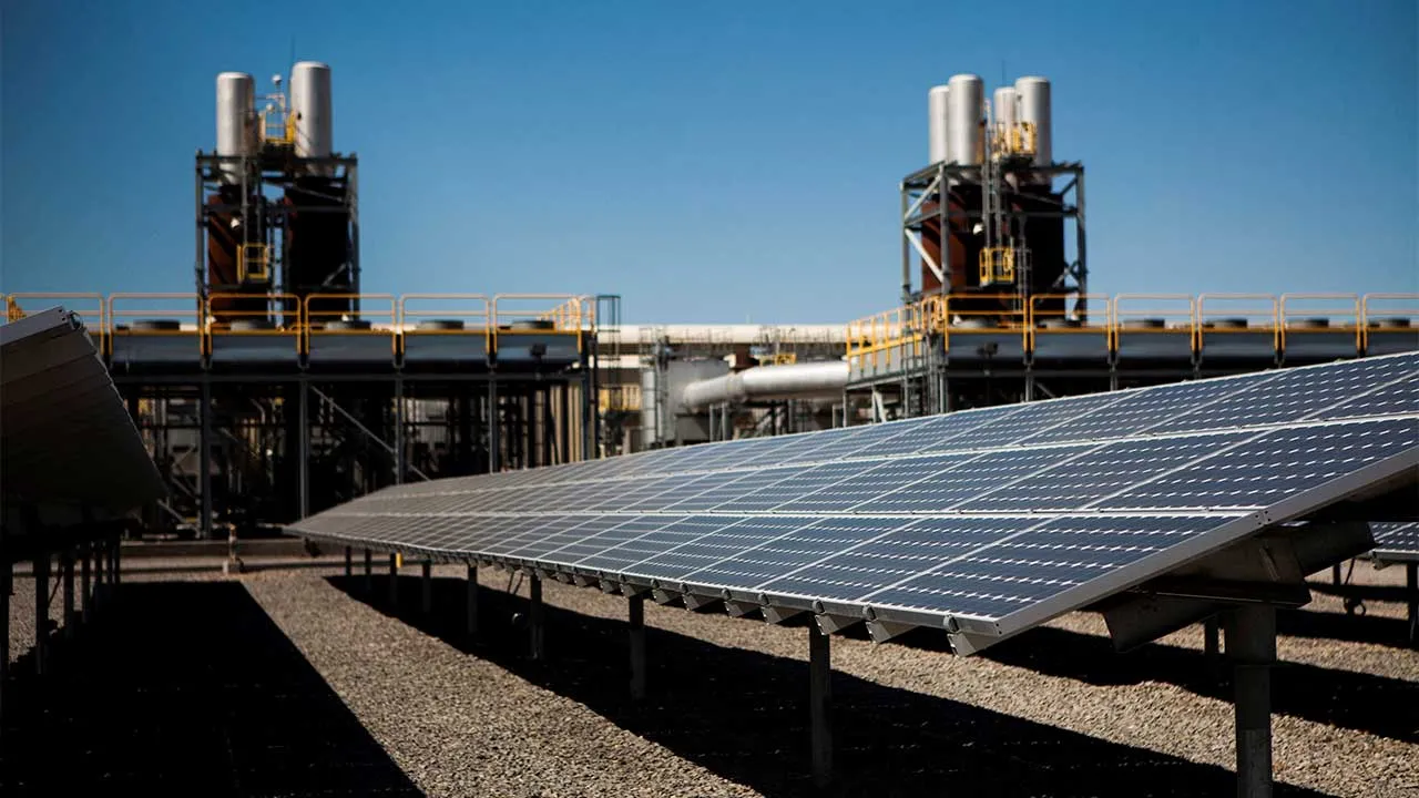 FILE PHOTO: FILE PHOTO: Solar panels are seen in front of a natural gas power plant at the Tahoe-Reno Industrial Center in McCarran, Nevada, September 16, 2014. This industrial site is where Elon Musk's electric car maker Tesla Motors plans to build a $5 billion factory to produce lithium ion batteries for electric cars, helped by more than $1 billion of incentives provided by Nevada. Tesla may employ 6,500 people at the new plant. In the past three years, 50 companies have moved to this area, helping cut u