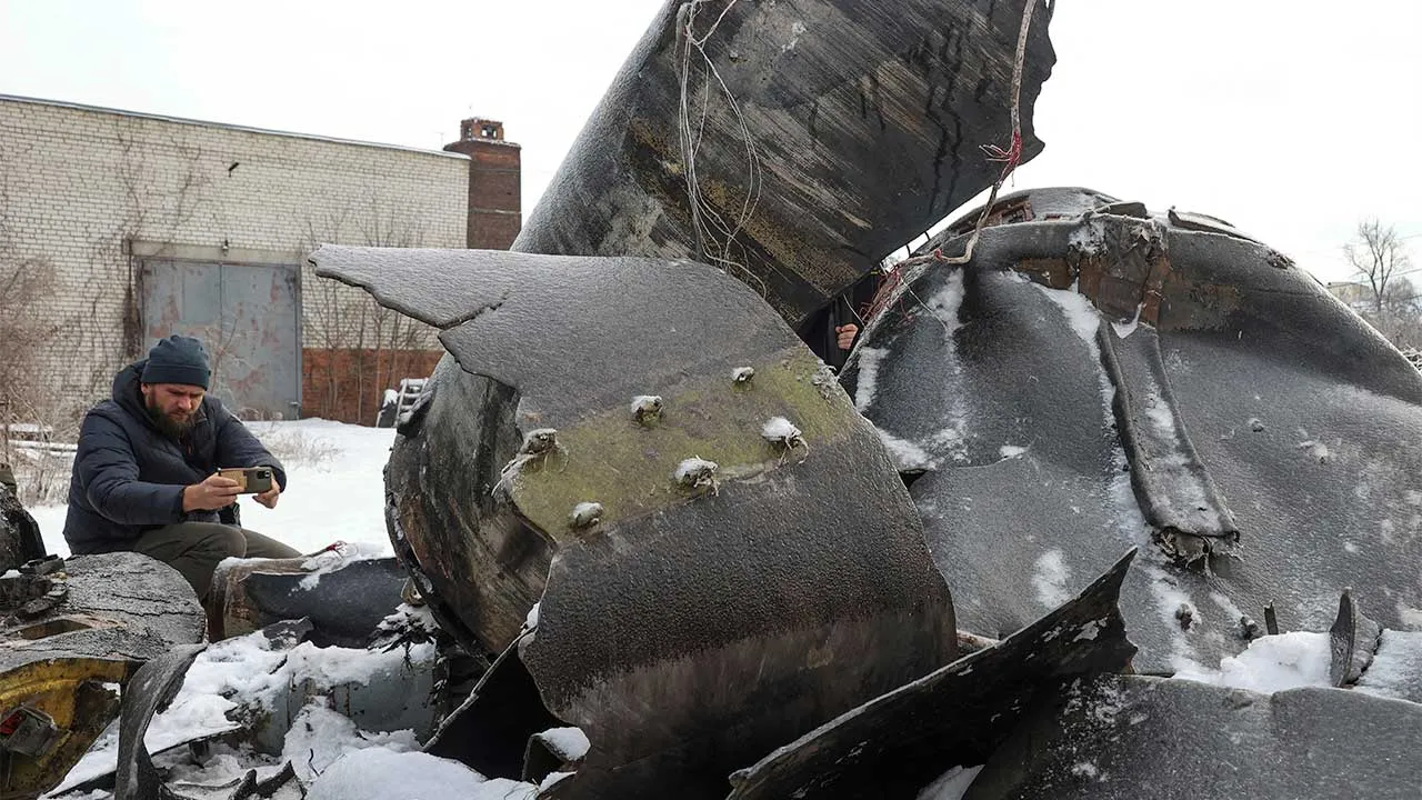 FILE PHOTO: A man photographs parts of an unidentified missile, which Ukrainian authorities believe to be made in North Korea and was used in a strike in Kharkiv earlier this week, amid Russia's attack on Ukraine, in Kharkiv, Ukraine January 6, 2024. REUTERS/Vyacheslav Madiyevskyy/File Photo