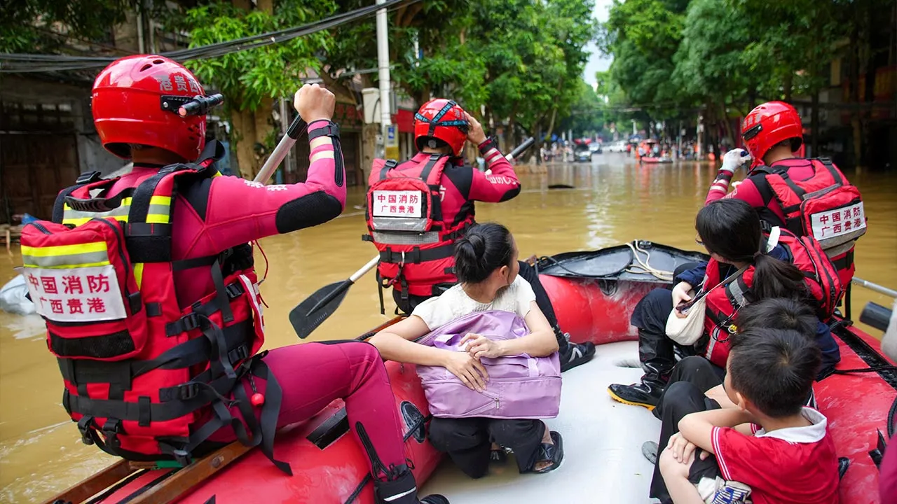 Rescue workers evacuate flood-affected residents by boat after heavy rainfall brought by typhoon Narra caused flooding in Longzhou county, Chongzuo, Guangxi Zhuang Autonomous Region, China August 24, 2026. cnsphoto via REUTERS ATTENTION EDITORS - THIS IMAGE WAS PROVIDED BY A THIRD PARTY. CHINA OUT. NO COMMERCIAL OR EDITORIAL SALES IN CHINA