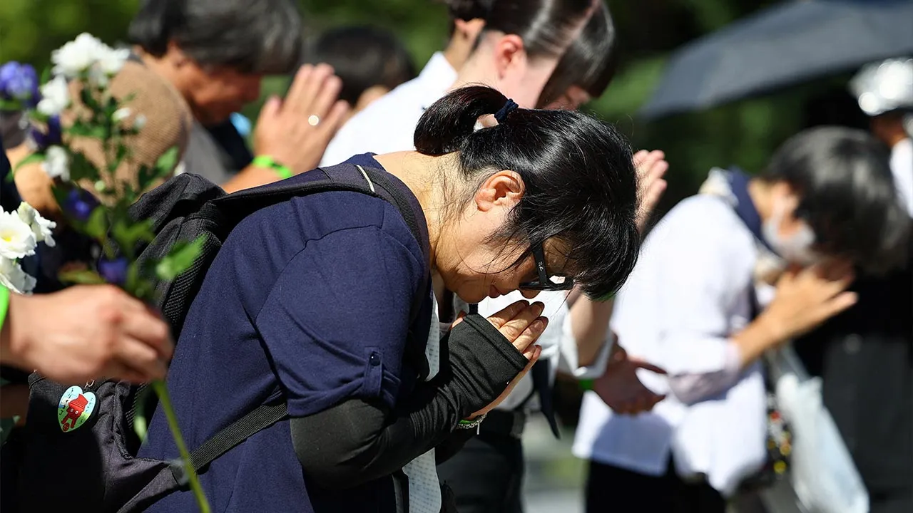 A woman prays for the victims of the 1945 atomic bombing on the 81st anniversary of the bombing, at Hiroshima Peace Memorial Park in Hiroshima, western Japan, August 6, 2026. REUTERS/Issei Kato