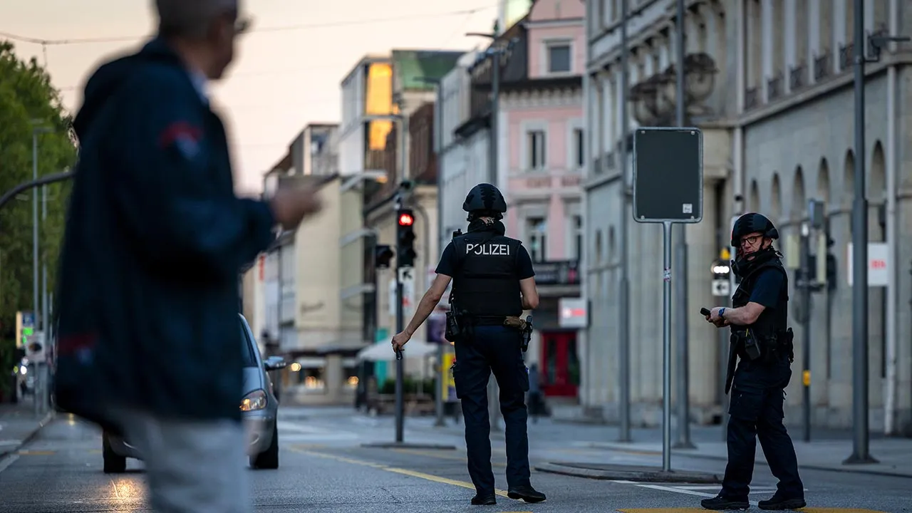 Police officers patrol a street in downtown Aarau, Switzerland Sunday, Aug. 30, 2026, following a shooting at a rave. (Michael Buholzer/Keystone via AP)