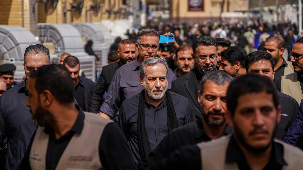 Iran's Foreign Minister Abbas Araghchi, center, is surrounded by security personnel as he walks in Najaf, Iraq, during Arbaeen commemorations, Monday, Aug. 3, 2026. (AP Photo/Anmar Khalil)