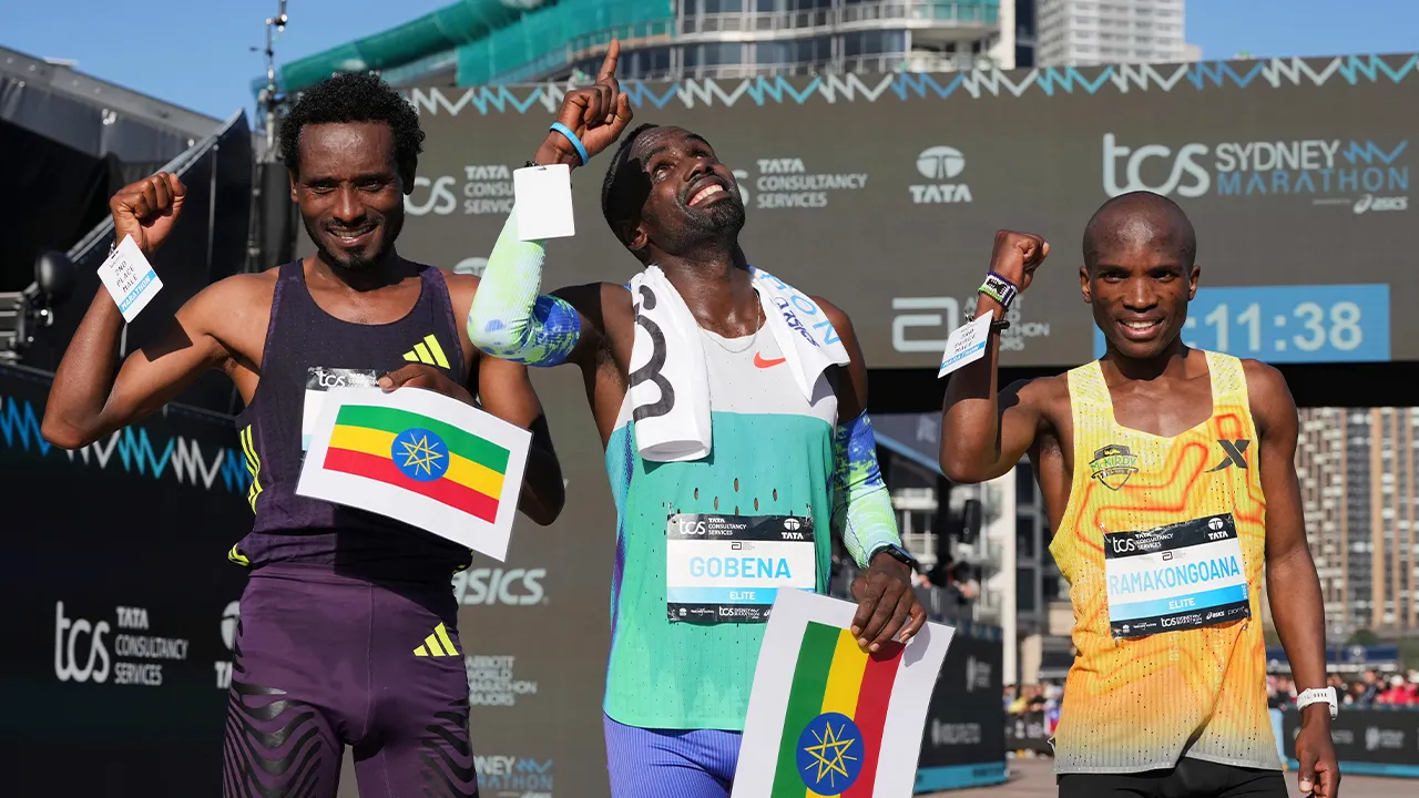 Race winner Addisu Gobena, centre, of Ethiopia stands with compatriot and second placed Chimdessa Debele, left, and third placed Tebello Ramakongoana of Lesotho following the Sydney Marathon, in Sydney, Sunday, Aug. 30, 2026. (AP Photo/Mark Baker)