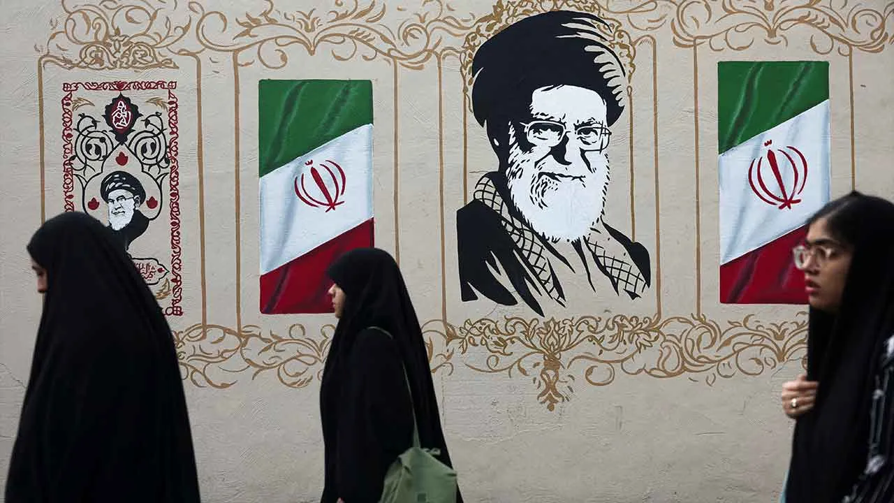 People walk by a mural depicting Iran's late Supreme Leader Ayatollah Ali Khamenei, on a street in Tehran, Iran, August 13, 2026. Majid Asgaripour/WANA (West Asia News Agency) via REUTERS ATTENTION EDITORS - THIS PICTURE WAS PROVIDED BY A THIRD PARTY. ISRAEL OUT. NO COMMERCIAL OR EDITORIAL SALES IN ISRAEL. NO ACCESS FOR ISRAELI MEDIA. NO USE BBC PERSIAN. NO USE VOA PERSIAN. NO USE MANOTO. NO USE IRAN INTERNATIONAL. NO USE RADIO FARDA. DIGITAL: NO USE BBC PERSIAN. NO USE VOA PERSIAN. NO USE MANOTO. NO USE IR