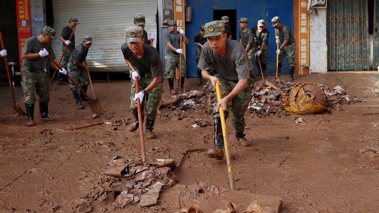 Militia members clear mud and debris after floods triggered by heavy rain from Typhoon Narra, in Ningming county, Chongzuo, Guangxi Zhuang Autonomous Region, China August 28, 2026. cnsphoto via REUTERS
