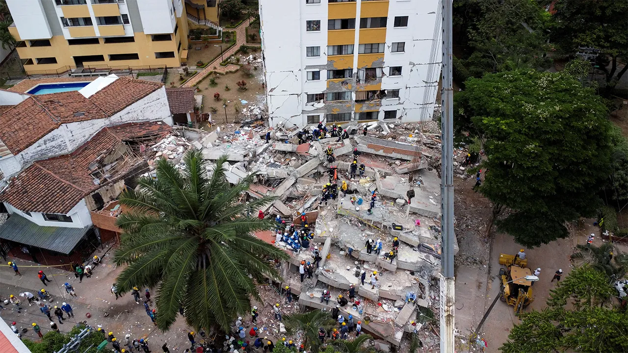 A drone view shows rescuers and emergency personnel searching for casualties and clearing the debris at a site of a collapsed residential building following an earthquake, in Cali, Colombia, August 12, 2026. REUTERS/Raquel Cunha