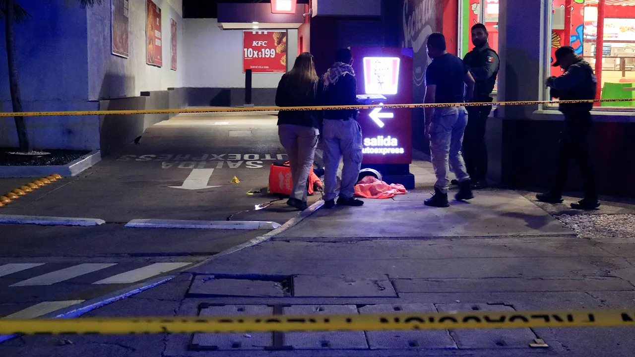 Forensic technicians and police officers work at the crime scene where Mexican social media influencer Cesar Gastelum, known for his comedy videos and followed by nearly 600,000 people on TikTok, was shot and killed while livestreaming with friends outside a fast-food restaurant in Culiacan, Sinaloa state, Mexico, August 4, 2026. REUTERS/Jesus Bustamante