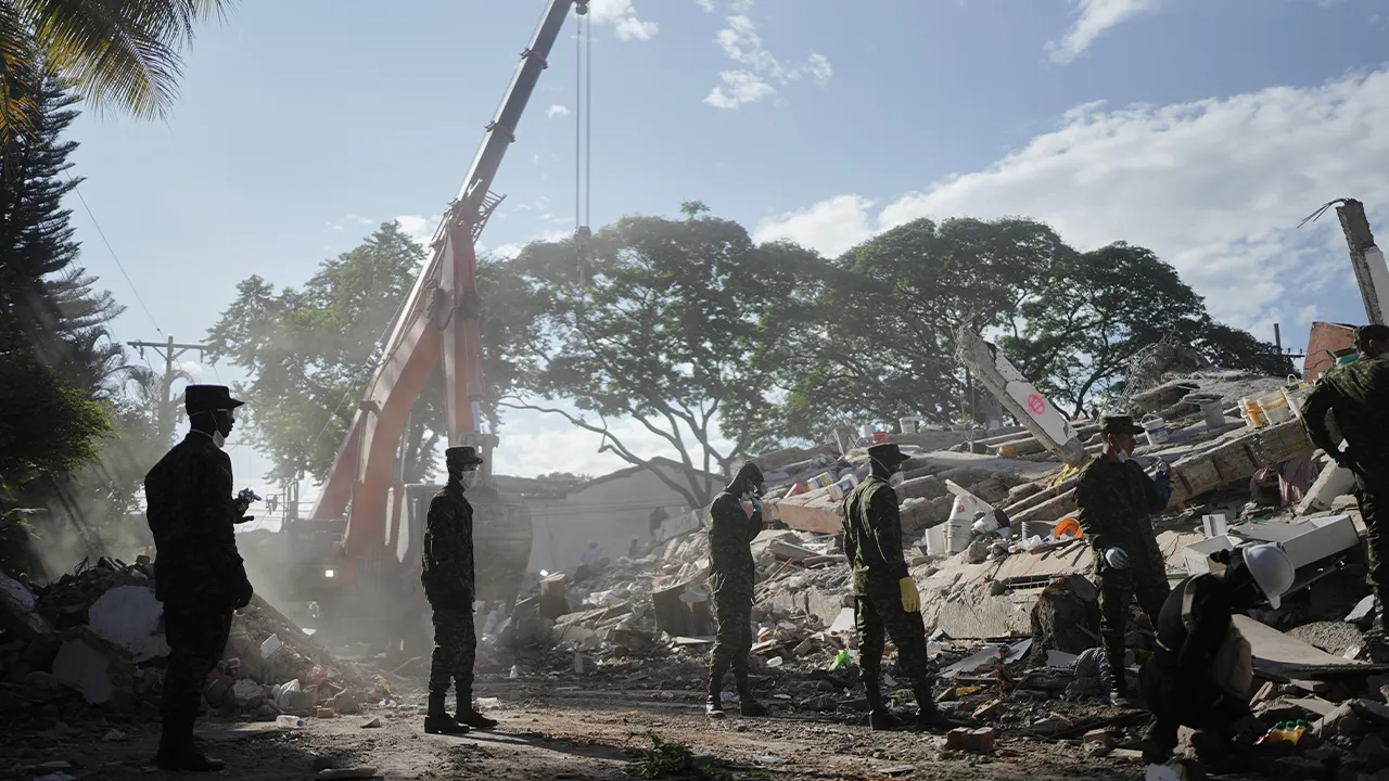 Soldiers clear debris three days after an earthquake struck Cali, Colombia, Thursday, Aug. 13, 2026. (AP Photo/Ivan Valencia)