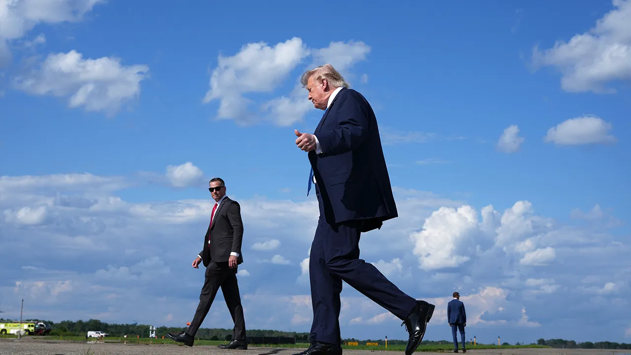 President Donald Trump walks from Air Force One to board Marine One at Morristown Municipal Airport in Morristown, N.J., Friday, July 31, 2026, following a trip to Camp David, the presidential retreat. (AP Photo/Jacquelyn Martin)