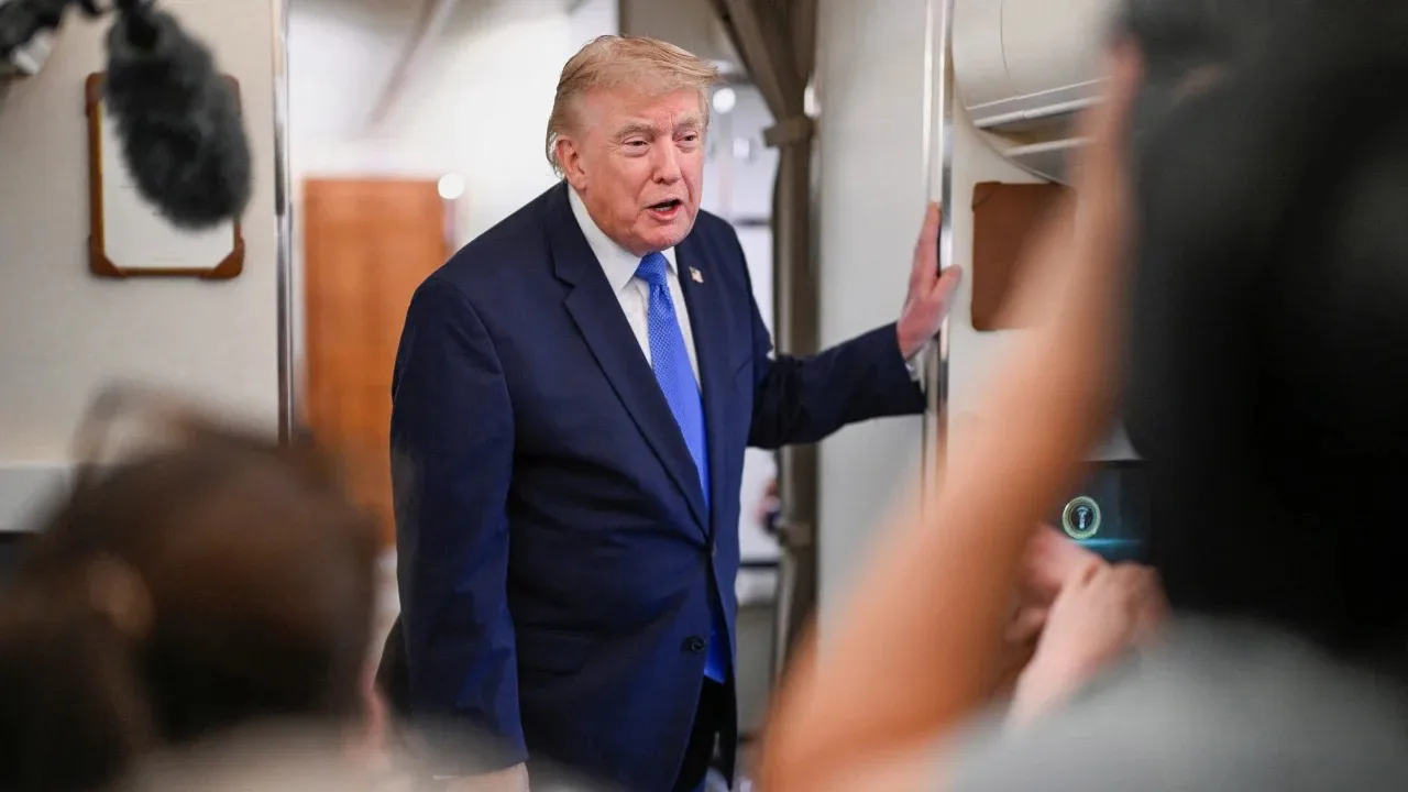 US President Donald Trump speaks to the media aboard Air Force One en route to Joint Base Andrews, in Maryland, August 2. Daniel Heuer/Reuters