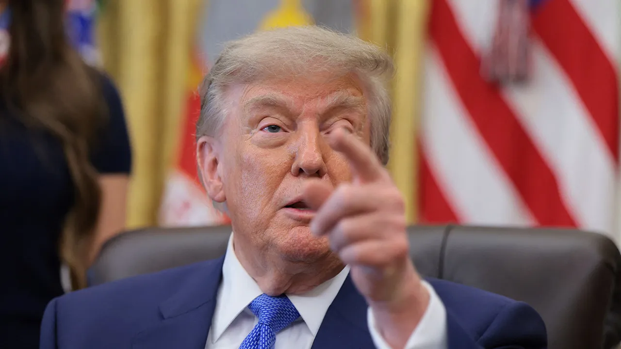U.S. President Donald Trump points as he speaks, during an event to sign an executive order regarding vaccine flexibility, in the Oval Office at the White House in Washington, D.C., U.S., August 10, 2026. REUTERS/Kylie Cooper