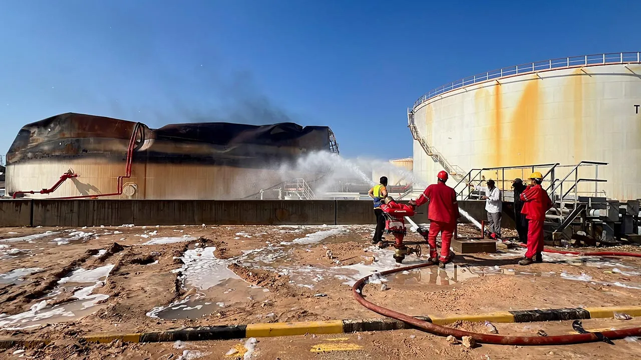 Firefighters work to extinguish the remaining fire in the Zawiya oil complex following drone strikes, in Zawiya, Libya, August 12, 2026. REUTERS/Hamza Al Ahmar