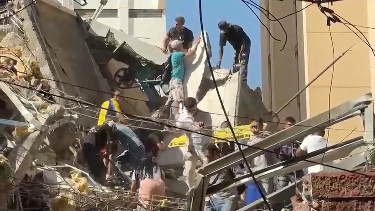 Rescue workers and residents stand atop a collapsed building in the aftermath of an earthquake in Cali, Colombia, August 10, 2026 in this screengrab taken from a video. REUTERS/Reuters TV