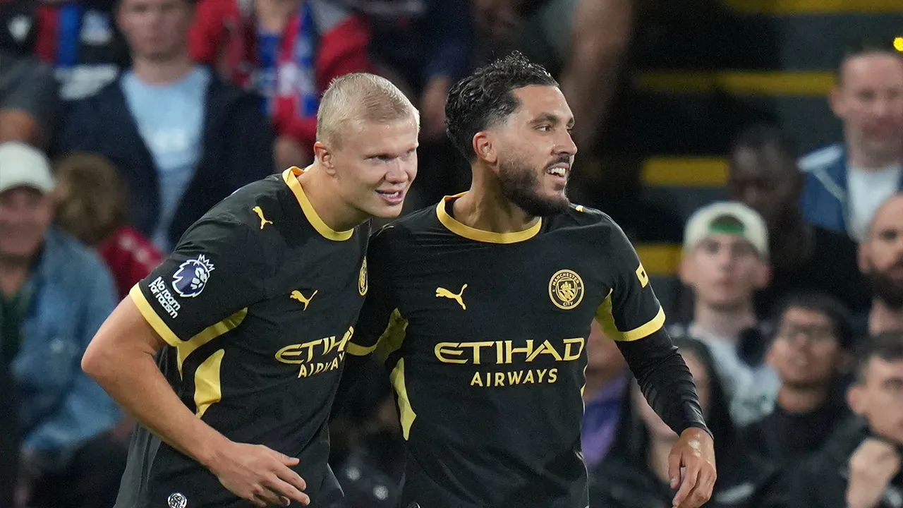 Manchester City's Rayan Cherki, right, celebrates with Erling Haaland after scoring his side's third goal during the English Premier League soccer match between Crystal Palace and Manchester City in London, Friday, Aug. 28, 2026. (AP Photo/Kin Cheung)