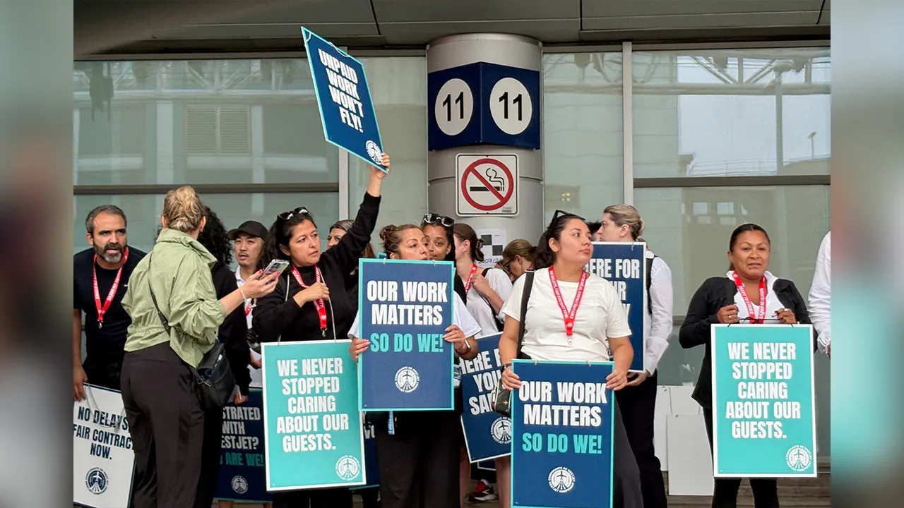 Flight attendants at Canada's WestJet hold placards while on strike after failing to reach a deal with the country's second-largest carrier, at Toronto’s Pearson Airport, in Mississauga, Canada, August 2, 2026. REUTERS/Caroline Stauffer