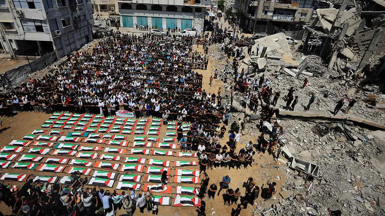 Palestinians attend the funeral of 112 members of the Hassayna and Abu Sharia clan, who were killed in an Israeli strike in 2023 and whose remains were recovered from beneath the rubble, according to Gaza's Civil Defense, in Gaza City, August 4, 2026. REUTERS/Dawoud Abu Alkas