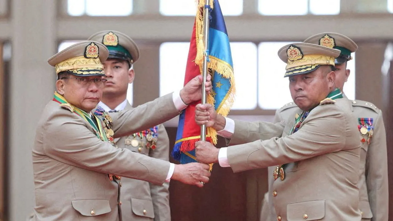 FILE PHOTO: Myanmar junta chief Senior General Min Aung Hlaing hands over a flag to newly appointed Commander-in-Chief General Ye Win Oo during a ceremony in Naypyitaw, Myanmar, March 30, 2026. Myanmar Military True News Information Team/Handout via REUTERS ATTENTION EDITORS - THIS IMAGE HAS BEEN SUPPLIED BY A THIRD PARTY./File Photo