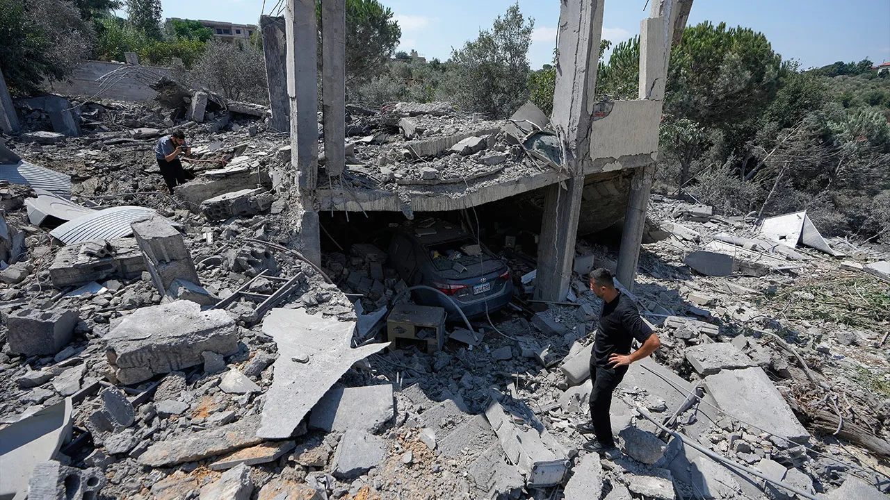 People check debris of a destroyed house that was hit on Thursday in an Israeli airstrike in Arab Salim village, southern Lebanon, Friday, Aug. 28, 2026. (AP Photo/Mohammed Zaatari)