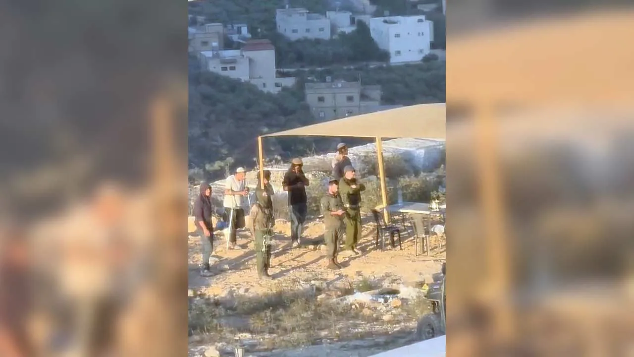 Israeli settlers and people in military uniforms stand outside a Palestinian's house in Qusra, in the Israeli-occupied West Bank, in this screengrab taken from a handout video released August 10, 2026. Video obtained by Reuters/Handout via REUTERS THIS IMAGE HAS BEEN SUPPLIED BY A THIRD PARTY. NO RESALES. NO ARCHIVES VERIFICATION: -Buildings, road layout and wall matched satellite imagery -Hills matched topographic mapping of the area -The exact date could not be verified, but Reuters reporting based on eye
