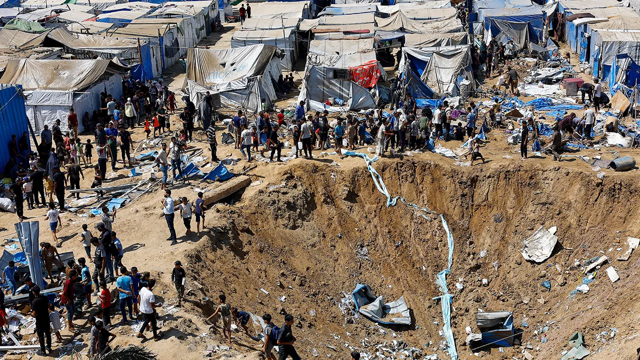 Palestinians inspect the site of an overnight Israeli strike on a medicine warehouse, according to medics, next to tents sheltering displaced Palestinians, in Deir al-Balah, in the central Gaza Strip, August 1, 2026, residents had been pre-warned by the Israeli military to evacuate. REUTERS