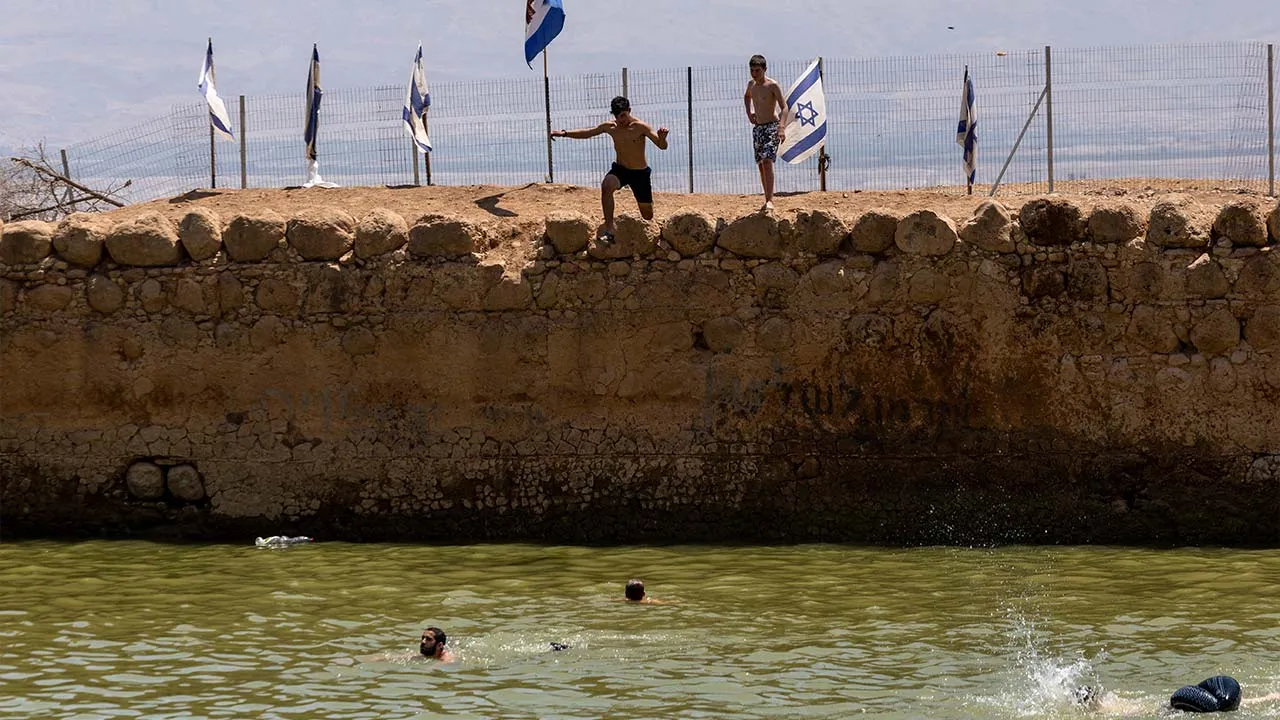Israelis prepare to jump into an ancient water reservoir in the Jordan Valley in the Israeli-occupied West Bank, August 5, 2026. REUTERS/Ronen Zvulun