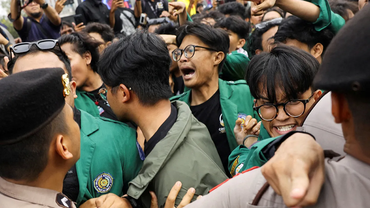 University students push against police officers during a protest against government policies, including state budget spending, free meals programme, and expanded military roles in civilian affairs, in Jakarta, Indonesia, August 18, 2026. REUTERS/Ajeng Dinar Ulfiana