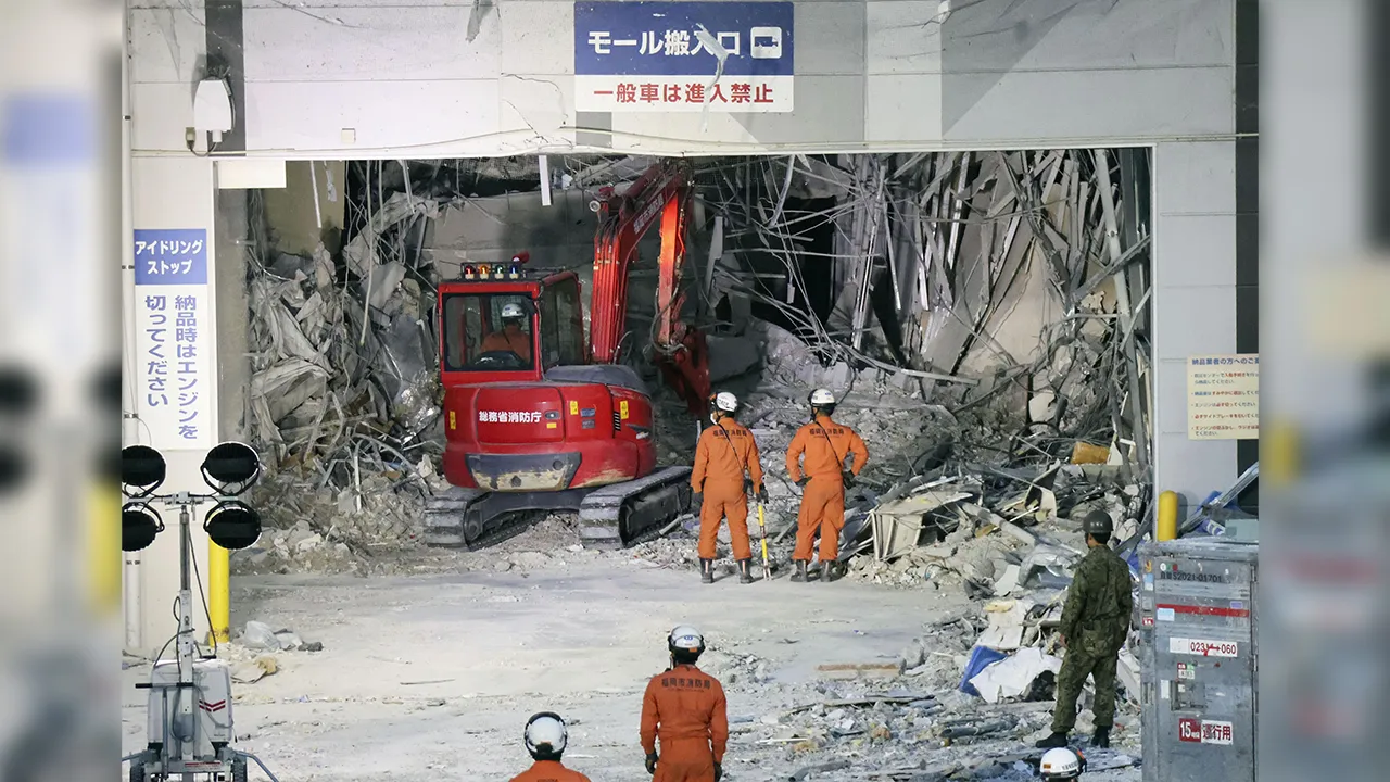 Heavy machinery removes debris at AEON Mall, which was damaged by an explosion following an earthquake, in Kashima, Kumamoto Prefecture, southern Japan, Friday, July 31, 2026. (Kyodo News via AP)