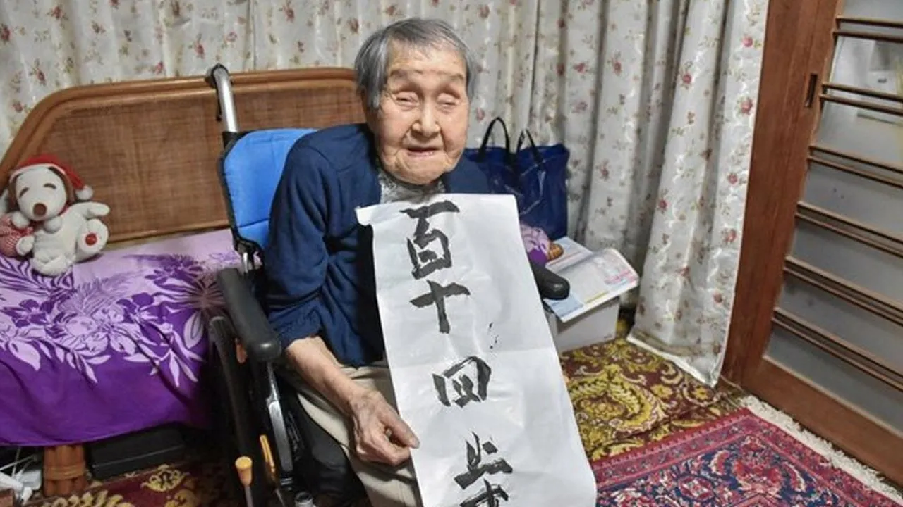File photo shows Shigeko Kagawa holding her calligraphy work in July 2025 in Yamatokoriyama, Nara Prefecture. (Photo courtesy of Yamatokoriyama city office)(Kyodo)