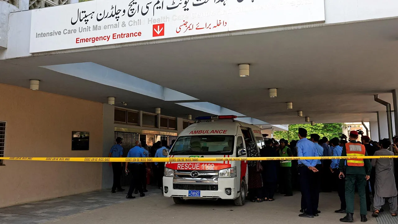 Police officers move past an ambulance outside an intensive care unit after a fire broke out at the Pakistan Institute of Medical Sciences (PIMS) hospital in Islamabad, Pakistan, August 26, 2026. REUTERS/Akhtar Soomro 