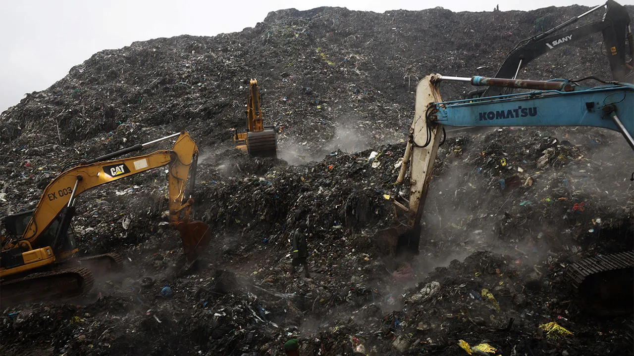 Rescue workers search through debris at a landfill after a landslide caused by heavy overnight rains killed people, in the Dar es Salam area in Conakry, Guinea, August 23, 2026. REUTERS/Souleymane Camara
