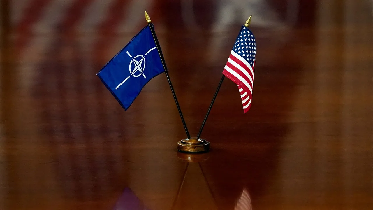NATO and U.S. flags are set on the table as U.S. Defense Secretary Pete Hegseth and NATO Secretary General Mark Rutte meet at the Pentagon in Washington, D.C., U.S., April 24, 2025. REUTERS/Nathan Howard