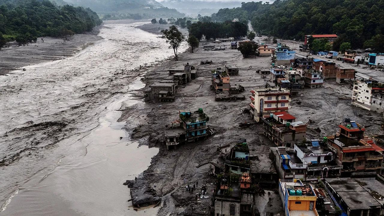 A drone view shows damaged buildings and houses covered in mud next to the Likhu River following deadly flash floods and mudslides, in Devighat, Nuwakot district, Nepal, August 30, 2026. REUTERS/Athit Perawongmetha