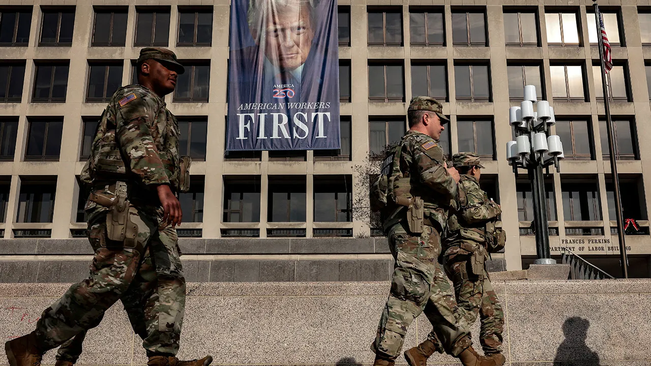 Members of the National Guard walk past the U.S. Department of Labor, which published its weekly initial jobless claims report for the week ending January 3, in Washington, D.C., U.S., January 8, 2026. REUTERS