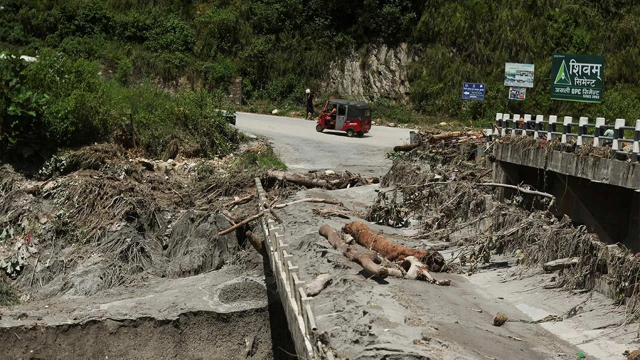 An auto rickshaw drives past a broken bridge following a flash flood in Galchhi, Nepal, August 27, 2026. REUTERS/Francis Mascarenhas
