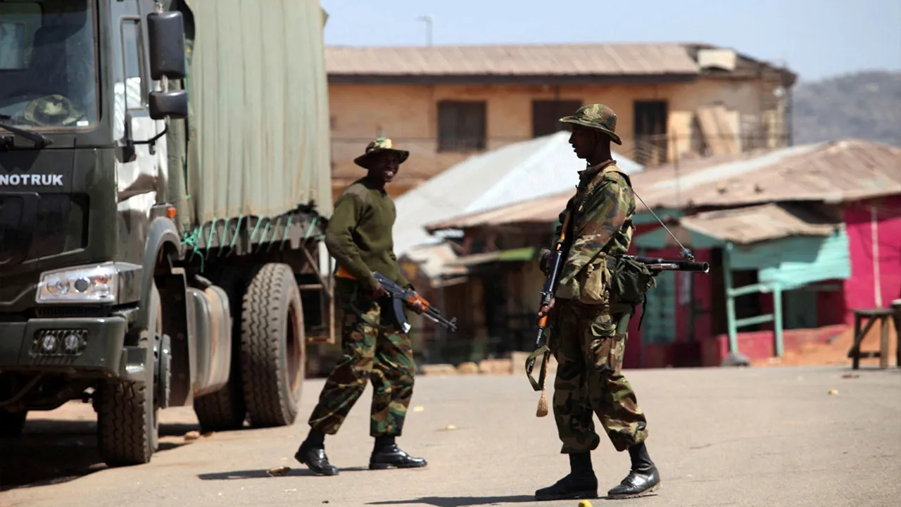 Soldiers stand guard along a road in Nigeria's central city of Jos January 20, 2010. REUTERS