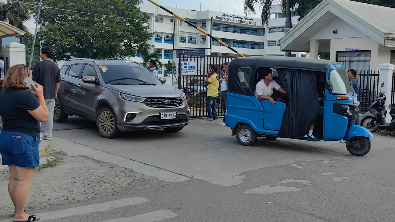 Vehicles exit the Ateneo de Zamboanga University following a shooting incident in Zamboanga, southern Philippines Tuesday, Aug. 18, 2026. (AP Photo) CORRECTION: Corrects date and day
