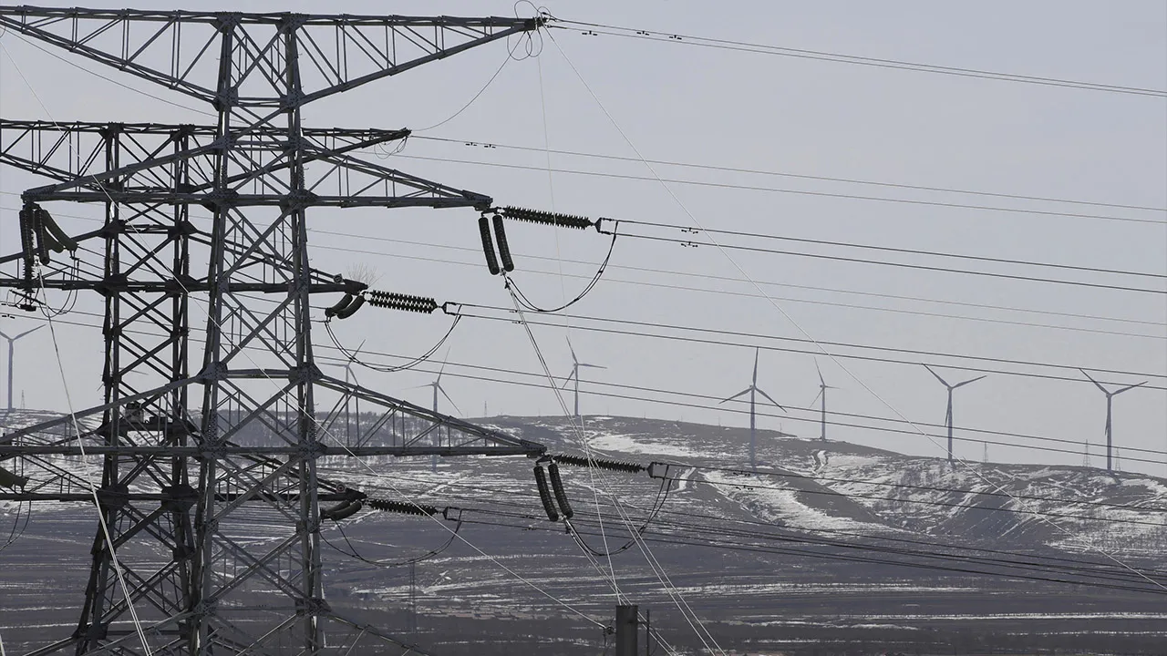 Power lines and wind turbines are pictured at a wind and solar energy storage and transmission power station of State Grid Corporation of China, in Zhangjiakou of Hebei province, China, March 18, 2016. REUTERS/Jason Lee