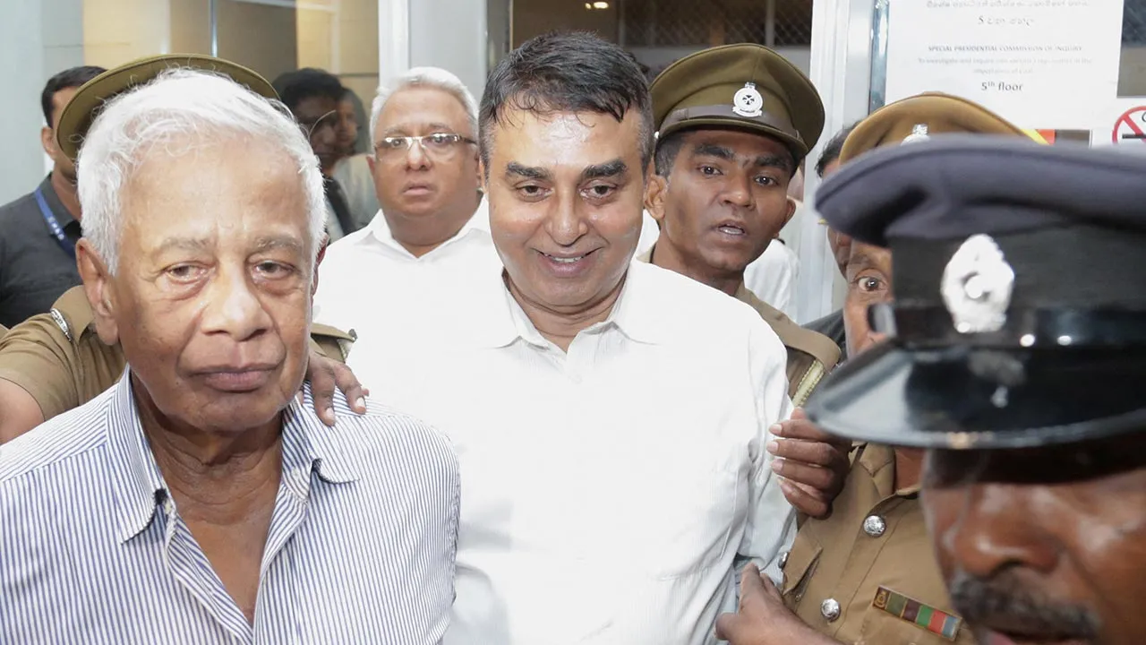 Sri Lanka's former police chief Pujith Jayasundara and former senior defence official Hemasiri Fernando are escorted by police officers after they were sentenced to death by a special court over the 2019 Easter bombings that killed 279 people, in Colombo, Sri Lanka, July 31, 2026. REUTERS/Stringer