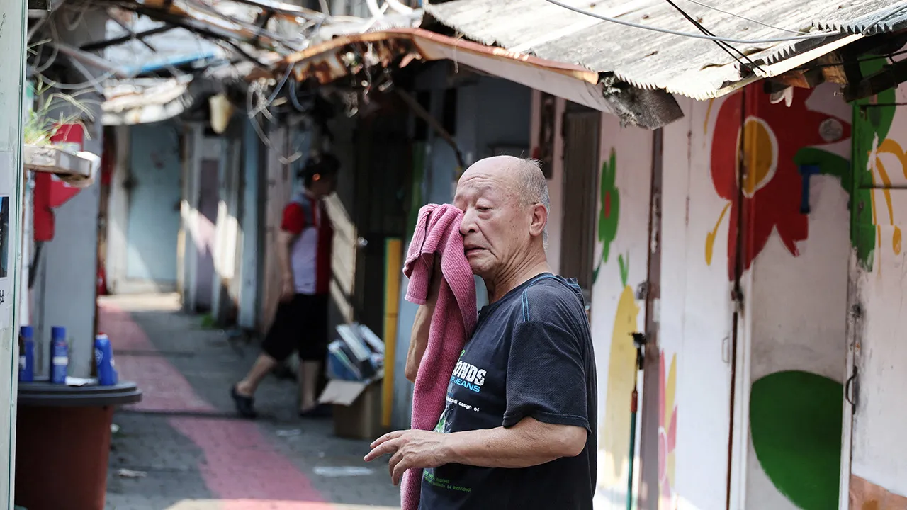 A man wipes off sweat at a jjokbang village which is a tiny single-room housing district, during the first-ever severe heatwave warning in Seoul, South Korea, August 4, 2026. REUTERS/Kim Hong-Ji