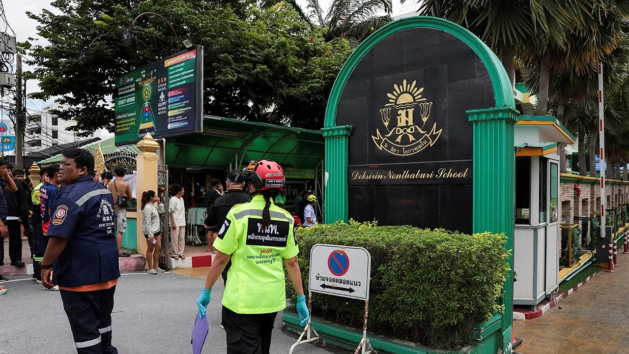People, including emergency personnel, gather outside Debsirin Nonthaburi School, the site of a shooting incident, in Bang Kruai district in Nonthaburi province on the outskirts of Bangkok, Thailand, August 7, 2026. REUTERS/Chalinee Thirasupa