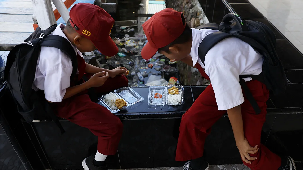 Students eat from plastic containers at a school in the fishing village of Torosiaje, Gorontalo province, Indonesia, July 27, 2026. REUTERS/Ajeng Dinar Ulfiana