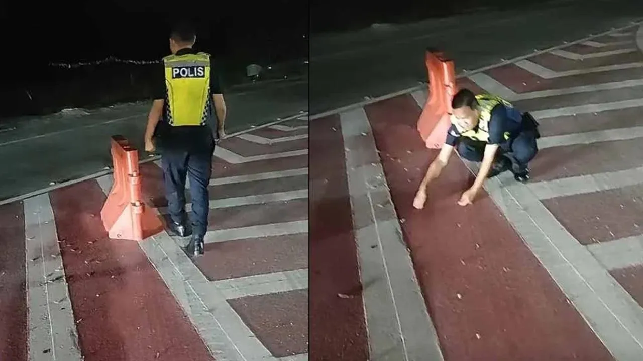 Tangkap layar video tular yang memaparkan seorang anggota polis mengutip paku yang ditabur pihak tidak bertanggungjawab di jejambat Cybersouth. -- SINAR HARIAN