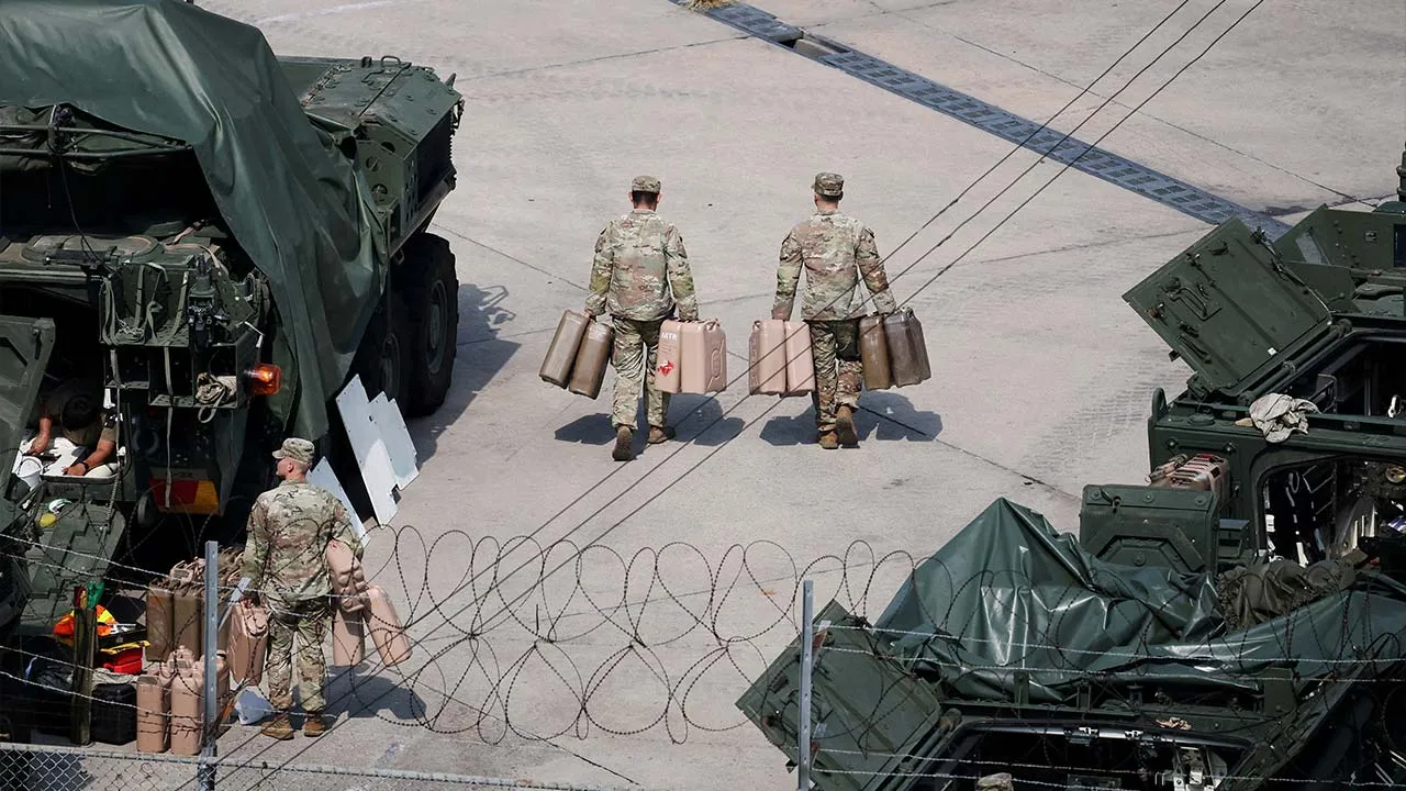 FILE PHOTO: U.S. Army soldiers move jerrycans at a U.S. army base near the demilitarized zone separating two Koreas, in Dongducheon, South Korea, August 18, 2026. REUTERS/Kim Hong-Ji/File Photo