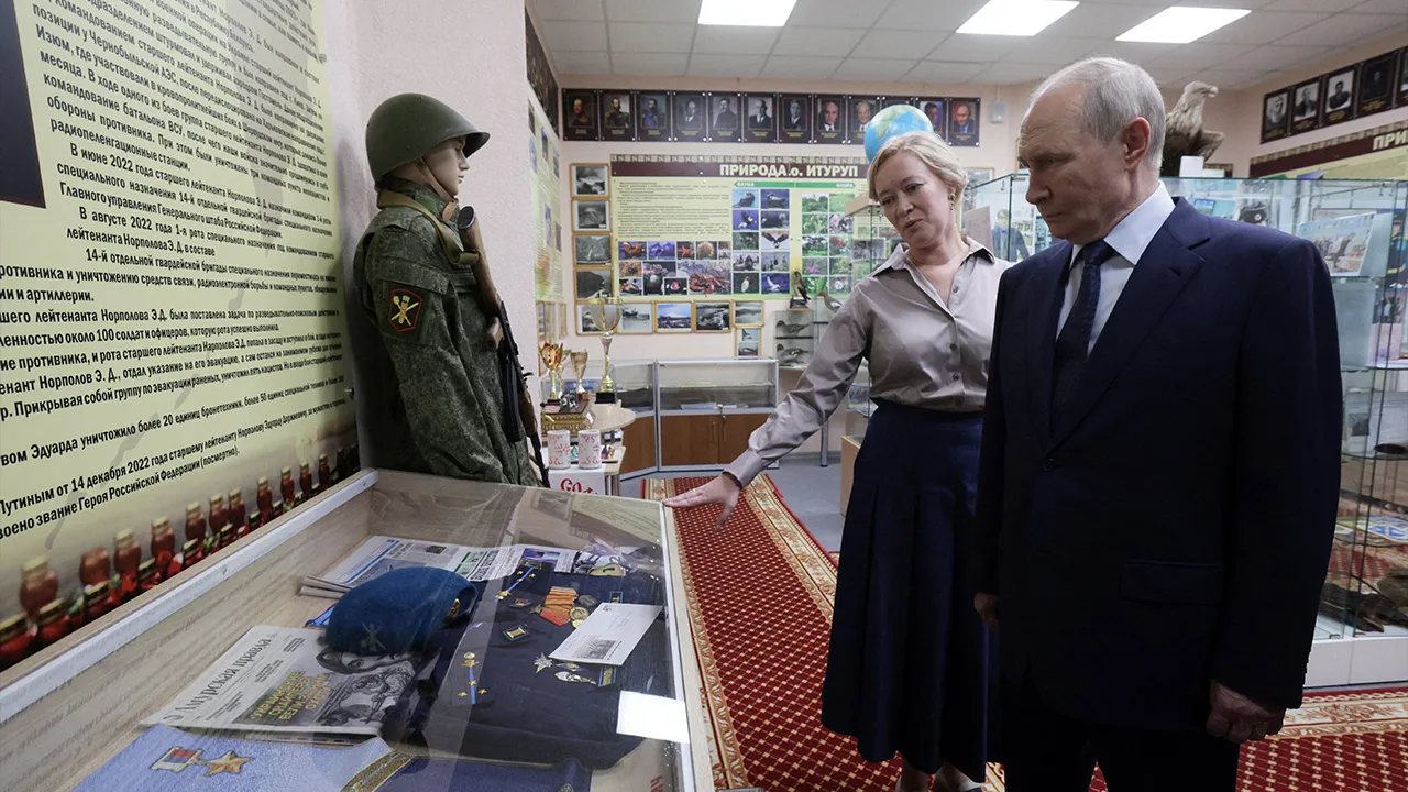 Russian President Vladimir Putin, accompanied by Sakhalin region Minister of Education Anastasia Kikteva, tours a museum of a local school during his visit on the Southern Kuril Island of Iturup, in far eastern Sakhalin Region, Russia, August 13, 2026. Sputnik/Gavriil Grigorov/Pool via REUTERS