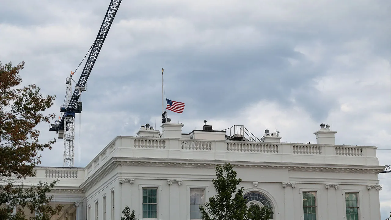 A U.S. flag flies at half-staff on top of the White House in memory of Dolly Parton, after it was announced that the country music icon died aged 80, in Washington, D.C., U.S., August 25, 2026. REUTERS/Kylie Cooper