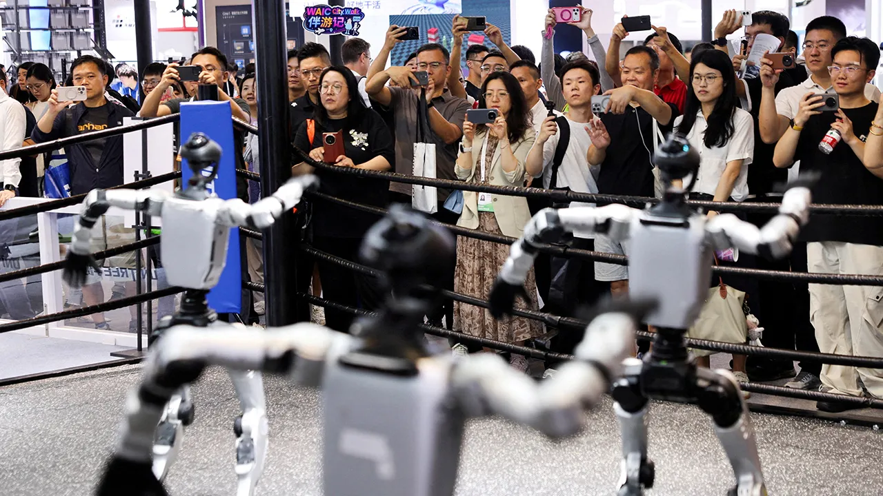 People watch humanoid robots dance at the Unitree booth during the World Artificial Intelligence Conference (WAIC) in Shanghai, China, July 17, 2026. REUTERS