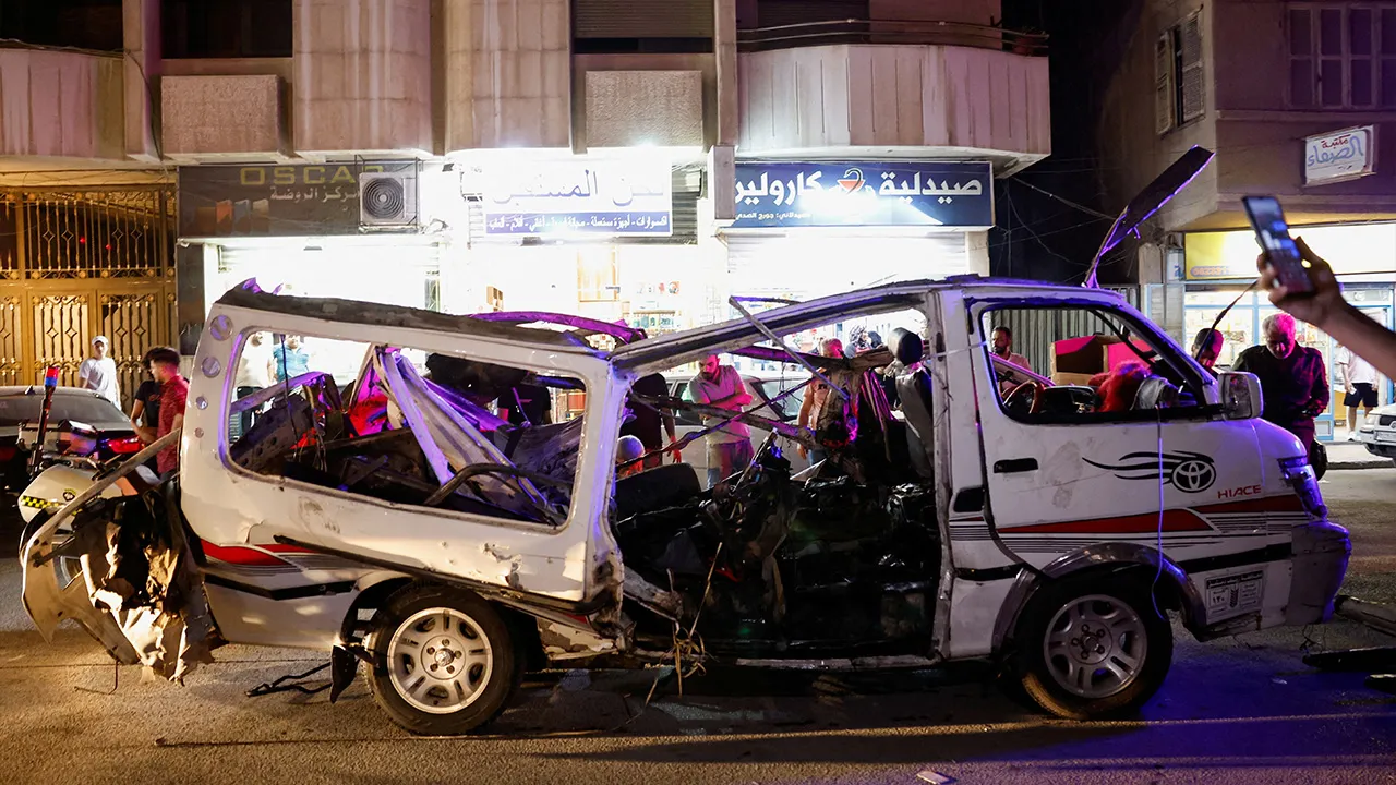 People look at a damaged vehicle following an explosion, in Jaramana, Damascus countryside, Syria, August 6, 2026. REUTERS
