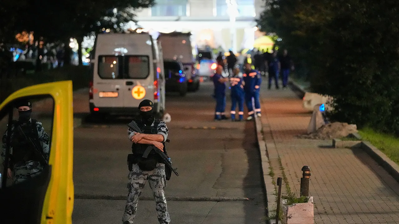 A policeman stands guard near the site where an improvised explosive device detonated at a restaurant in central Moscow, Saturday, Aug. 1, 2026. (AP Photo/Pavel Bednyakov)
