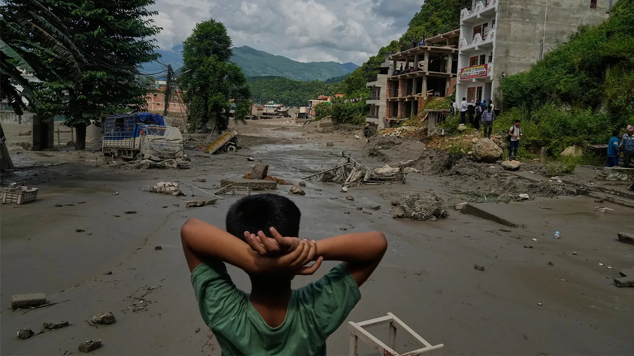 A boy looks at the devastation caused by flash flooding along the Trishuli River in Nepal's Nuwakot district, Wednesday, Aug. 26, 2026. (AP Photo/Niranjan Shrestha)